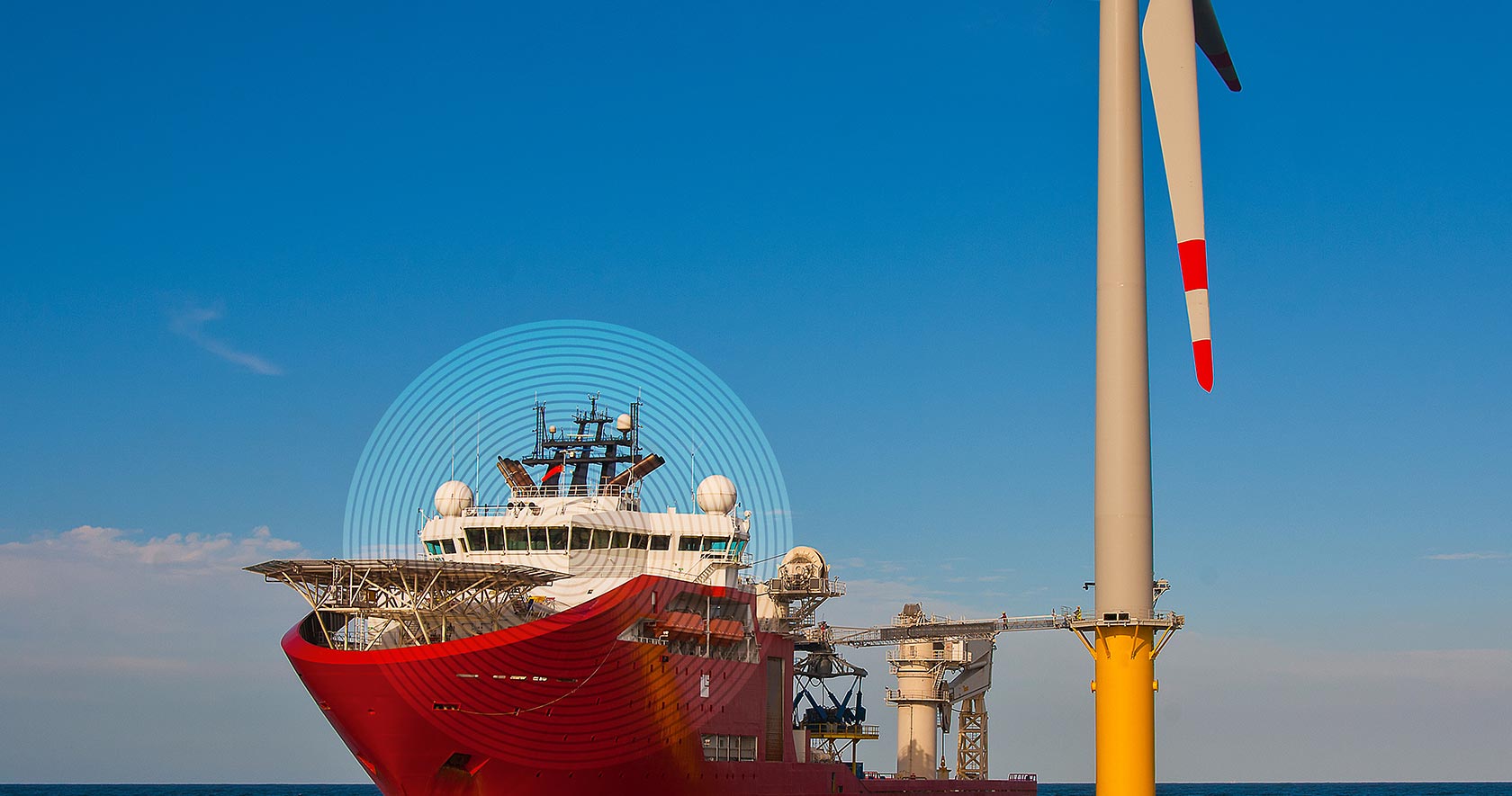 Offshore vessel with a graphic overlay near a wind turbine